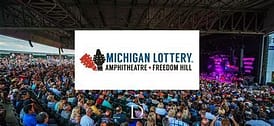 A large crowd of people sitting in front of the michigan lottery logo.