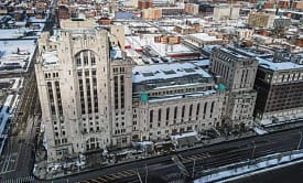 A large building with many windows and a train track