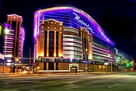 A large building with lights on it's side.